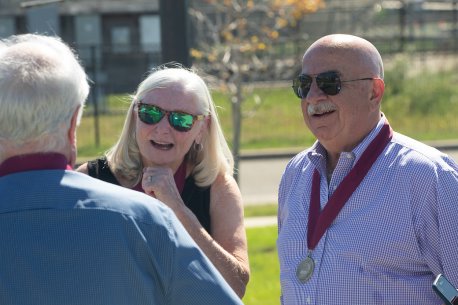 Three alumni gather outside for reunion weekend